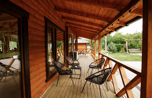 Wooden terrace in a modern country house, with an onboard platform and garden furniture - Fotó, kép