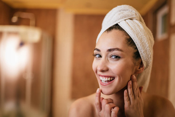 Young beautiful woman with clean and fresh face skin in the bathroom.  - 写真・画像