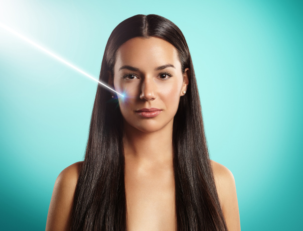 Woman with laser ray - Foto, imagen