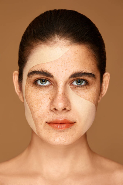 Portrait of beautiful woman with make-up on beige studio background. freckled girl with foundation on her face. difference with and without makeup - Фото, зображення