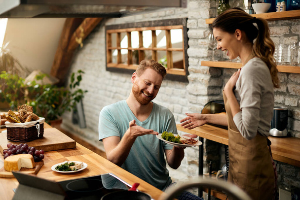 Happy man surprising his girlfriend with a breakfast in the kitchen.  - Fotografie, Obrázek