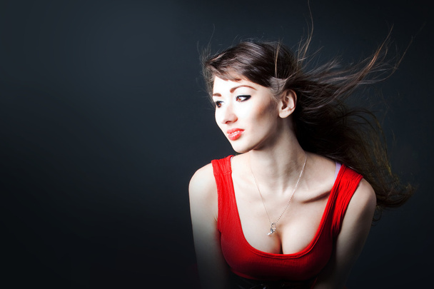 Young sexy woman in a red dress - Fotografie, Obrázek