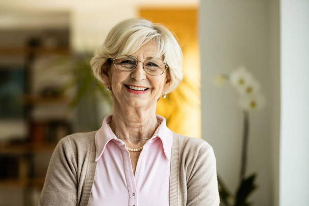 Portrait of happy mature woman looking at camera at home.  - Photo, image