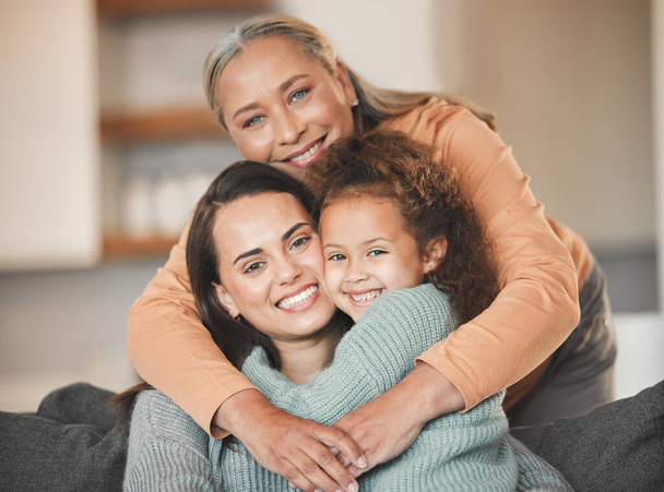 Portrait of a mature woman boding with her daughter and granddaughter on the sofa at home. - Photo, Image