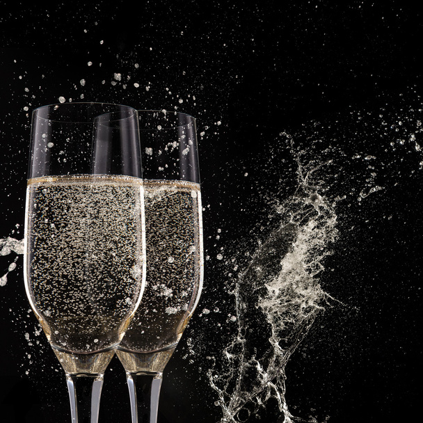 Champagne flutes on black background - Фото, изображение