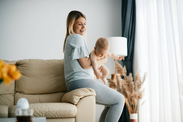 Playful mother having fun with her small son int he living room. Copy space.  - Valokuva, kuva