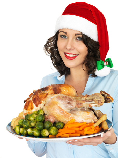 Young Woman in Santa Hat Holding Roast Turkey and Vegetables - Fotó, kép