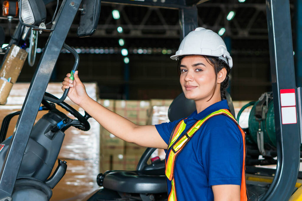 Female worker on forklift, Manual workers working in warehouse, Worker driver at warehouse forklift loader works - Foto, afbeelding