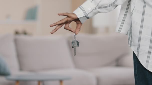 Close-up focus on apartment keys in hand of unrecognizable african american woman homeowner buying house mortgage bank client real estate agent realtor demonstrates advertises new modern apartments - Materiaali, video