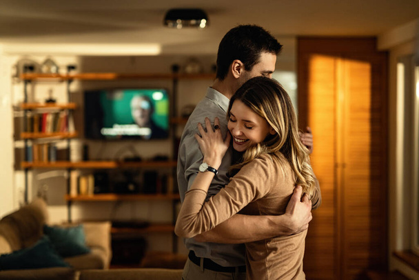 Young couple in love dancing in the living room.  - Valokuva, kuva