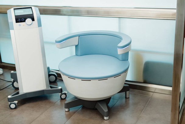 Electromagnetic chair for stimulation of deep pelvic floor muscles and restoring neuromuscular control at the clinic.  - Fotó, kép