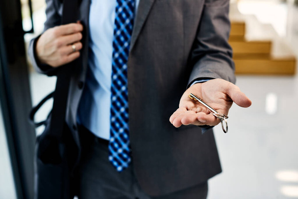 Close-up of real estate agent holding key of a new home. - Fotoğraf, Görsel