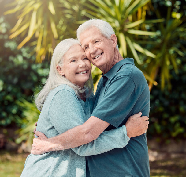 Cropped portrait of an affectionate senior couple outside in their garden at home. - 写真・画像