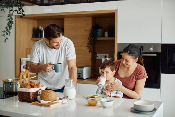 Happy family enjoying while having breakfast together in the morning at home.  - Fotografie, Obrázek