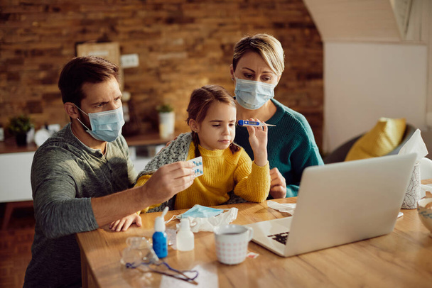 Worried parents and their ill daughter consulting a doctor via video call from home during coronavirus pandemic. - Photo, image