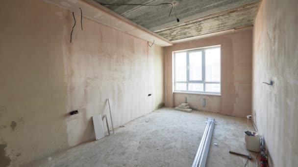 Comparison of old room with building materials and new renovated place with plastic window, parquet floor and gray walls. Video of modern apartment before and after renovation. - Filmagem, Vídeo