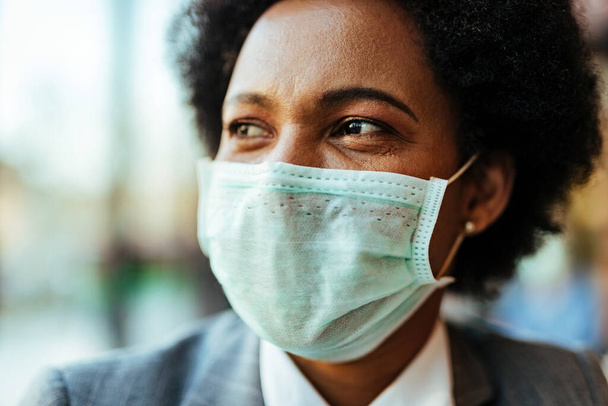 Close-up of black woman with face mask during virus epidemic. - Photo, image