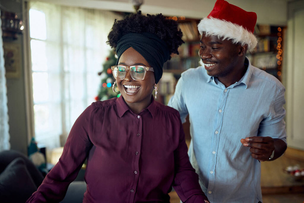 Young African American couple having fun and dancing on New Year's day at home. - Fotografie, Obrázek