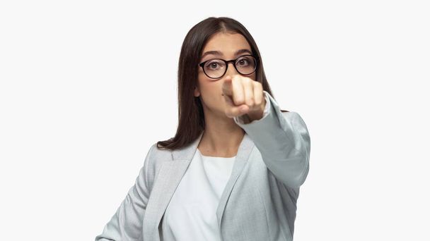 young businesswoman in grey blazer and eyeglasses pointing with finger isolated on white - Photo, image