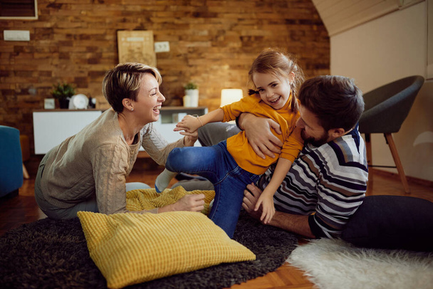 Carefree family having fun while playing at home.  - Foto, Bild