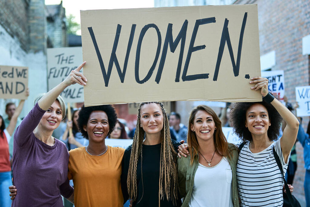 Multi-ethnic group of happy females on a demonstrations for women's rights. - Photo, image