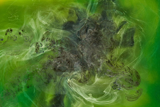 Liquid fluid art abstract background. Green dancing acrylic paints underwater, cosmic smoke ocean - Foto, Bild