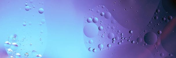 oil with bubbles on neon background. Abstract space background. Soft selective focus. macro of oil drops on water surface. copy space. air bubbles in water - Photo, image