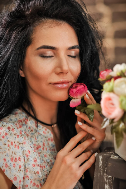 beautiful young woman with flowers in the garden - Zdjęcie, obraz