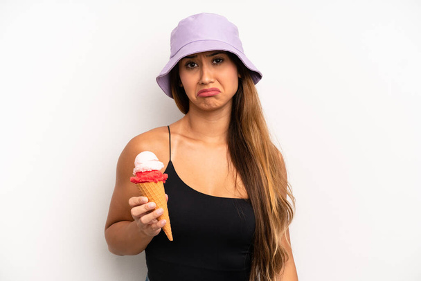 asian young woman feeling sad and whiney with an unhappy look and crying. summer and ice cream concept - Photo, image