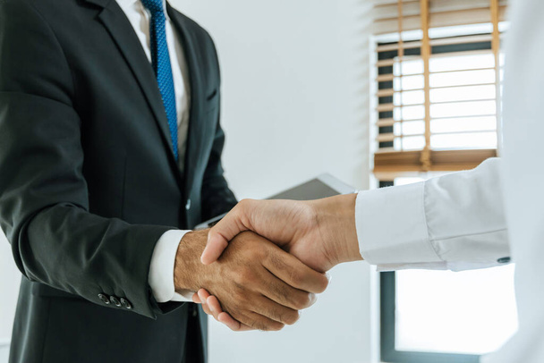 Deal. business people handshake after business signing contract document on desk in meeting room at company office, partnership, job interview, investor, negotiation, partnership and teamwork concept - Photo, image