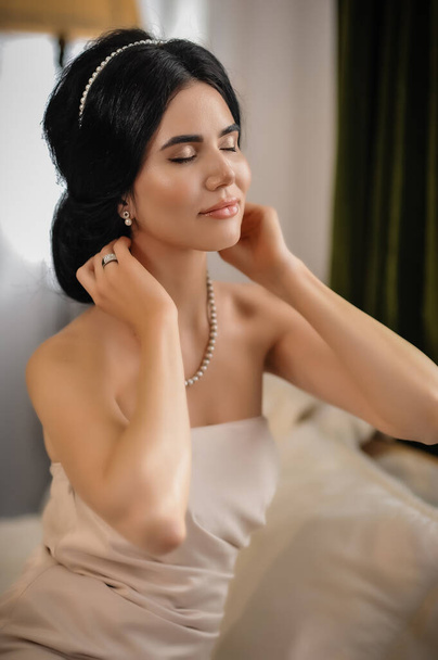 beautiful young woman in white dress posing in studio - Photo, Image