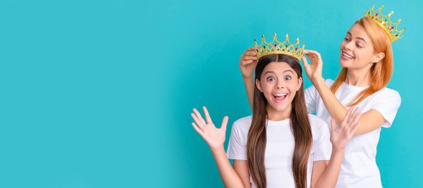 Mother and daughter child banner, copy space, isolated background. This is a happy surprise. Surprised child win crown. Happy mother crown daughter. Pageant girl - 写真・画像