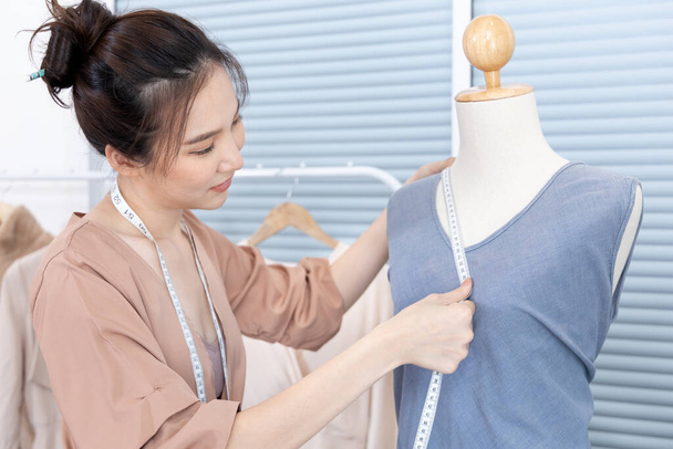 Professional female designers use a tape measure around the shirt mannequins in the studio, Fashion designer, Creativity and ideas, Mannequin, Shirt sketch, Color scheme, Garment accessories. - Photo, Image