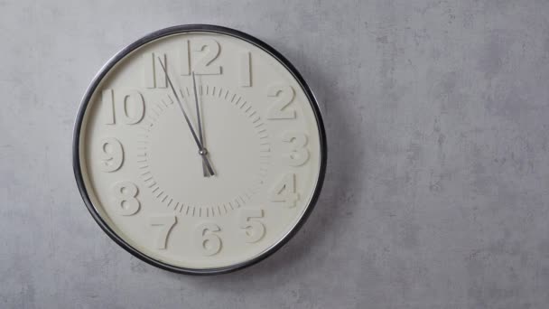 Wall clock on a gray background. Clock close-up. Watch face with large numbers. - Footage, Video