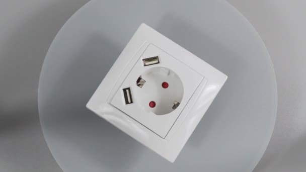 Socket with two USB Socket with two USB connectors. 220 volt European standard socket with two usb connectors for charging mobile devices. White plastic socket on a white background - Metraje, vídeo