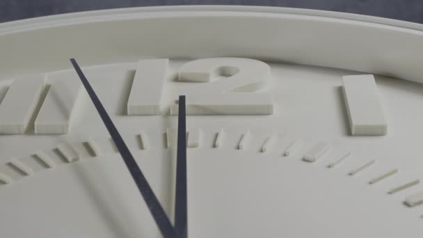 Wall clock on a gray background. Clock close-up. Watch face with large numbers. - Materiał filmowy, wideo