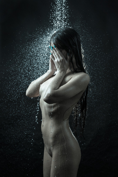 Naked girl under jet of water - Фото, изображение