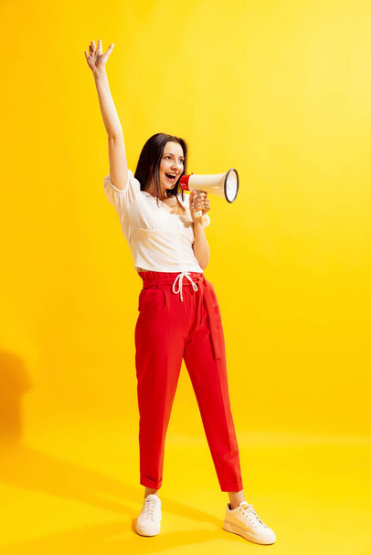 Info, breaking news, Young beautiful woman in summer casual style outfit isolated on bright yellow background. Concept of beauty, art, fashion, youth, healthy lifestyle. Copyspace for ads, offer. - Φωτογραφία, εικόνα