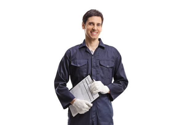 Man in a working uniform holding a clipboard isolated on white background - Фото, зображення