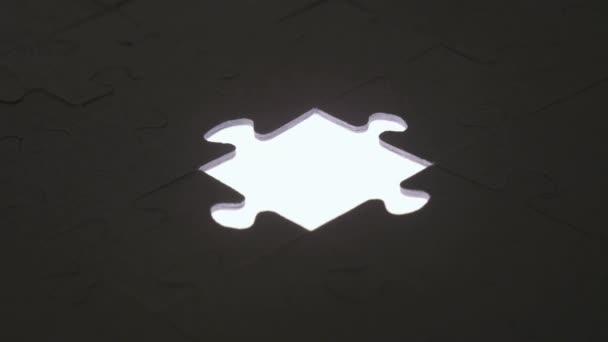 Last piece of jigsaw puzzle with silhouette light - Footage, Video