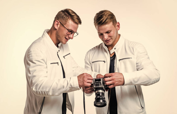 young twin brothers photographer with similar appearance make photo with retro camera, photography. - Photo, Image