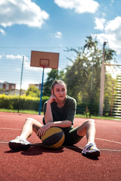 Image of a strong young sporty fitness woman basketball player holding a basketball for the game. Strong athletic woman with a ball - Фото, изображение