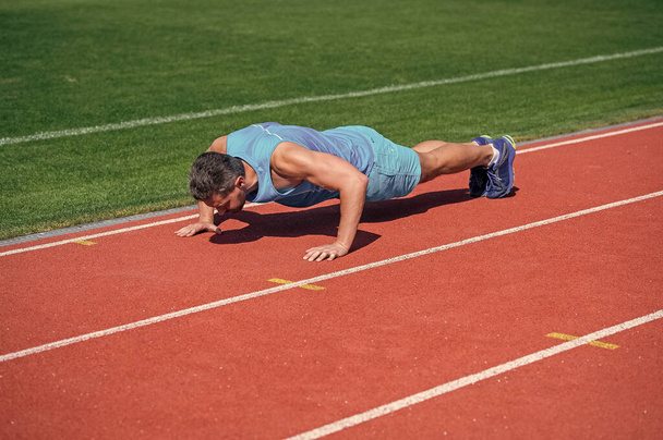male athlete do morning exercise. pushups workout. sportsman planking outdoor. health care. muscular guy training core muscles. man in plank. healthy lifestyle routine. sport success. - Foto, Imagem