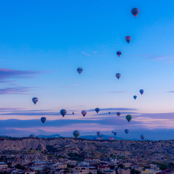 GOREME/TURKEY - June 29, 2022: dozens of hot air balloons take off at dawn to transport tourists. - 写真・画像