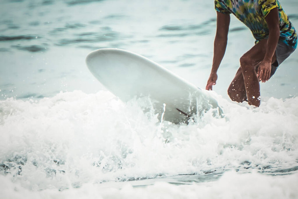 Blurred soft images of people are playing surfboard in the sea, a sport that requires strength and good balance, to people sport  concept. - Foto, immagini