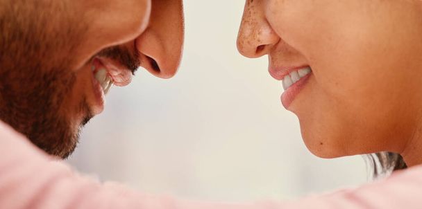 Closeup of mixed race man loving his asian wife. Headshot of hispanic couple bonding and sharing an intimate moment at home. Beautiful woman with freckles feeling in love with boyfriend. - Photo, Image