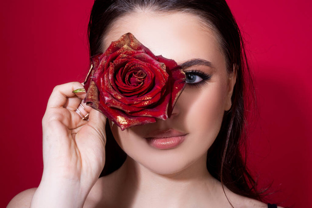 Portrait of attractive woman with red rose - Φωτογραφία, εικόνα