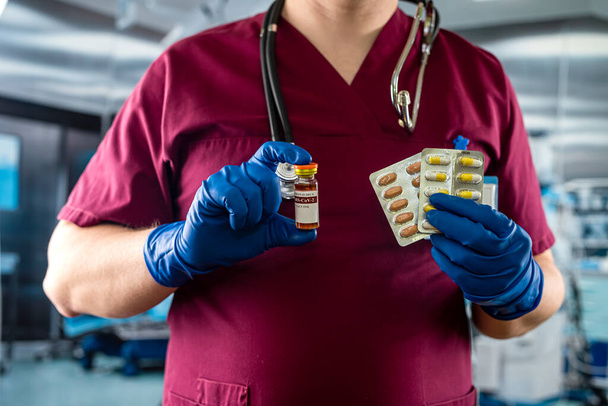 medical assistant hand in gloves holding vaccine or anesthesia vial bottle  in the surgical office at the hospital - Foto, imagen