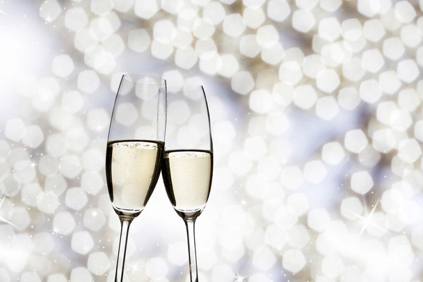 Toasting with champagne glasses on sparkling holiday background - Photo, Image