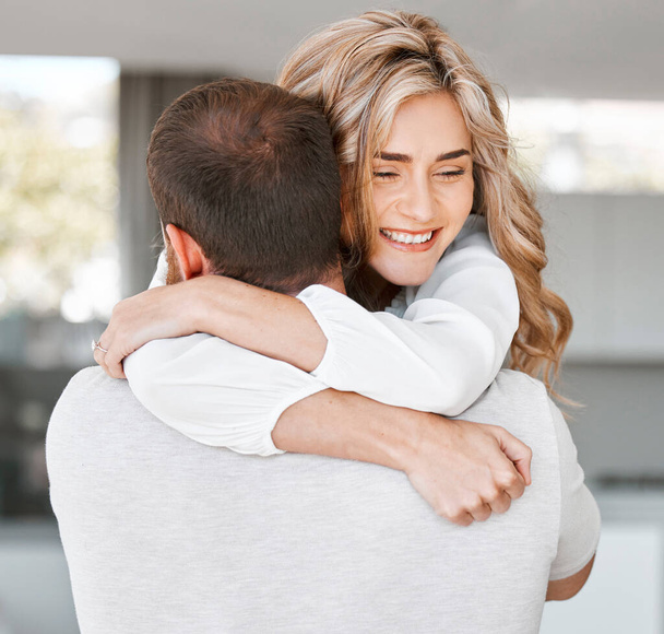 Excited woman hugging her boyfriend. Husband carrying his wife. Happy girlfriend hugging her boyfriend.Romantic couple hugging at home. Caucasian couple affectionately embracing - Photo, Image